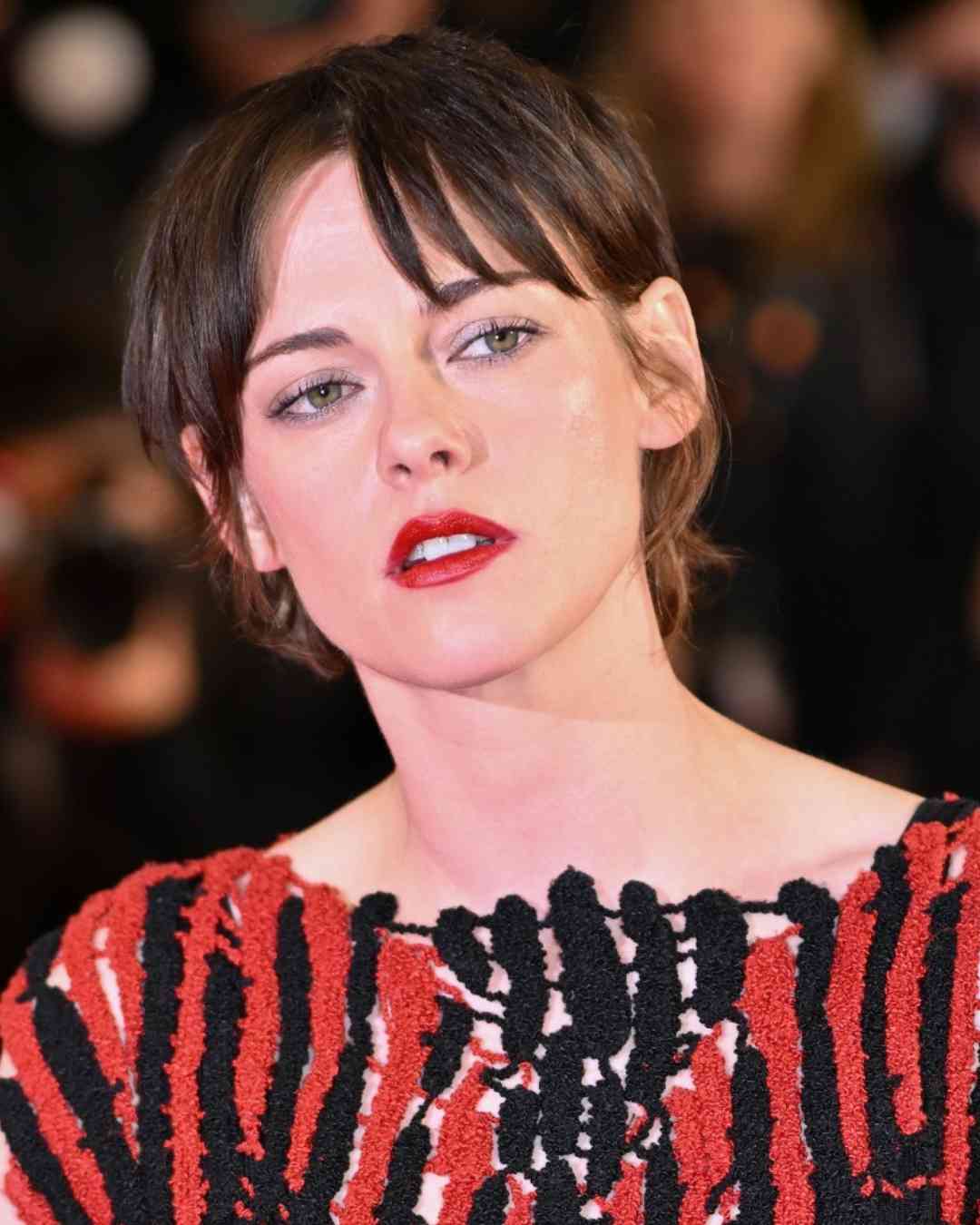 Kristen Stewart attended the premiere of her new comedy film Full Phil in a red-and-black Chanel gown.