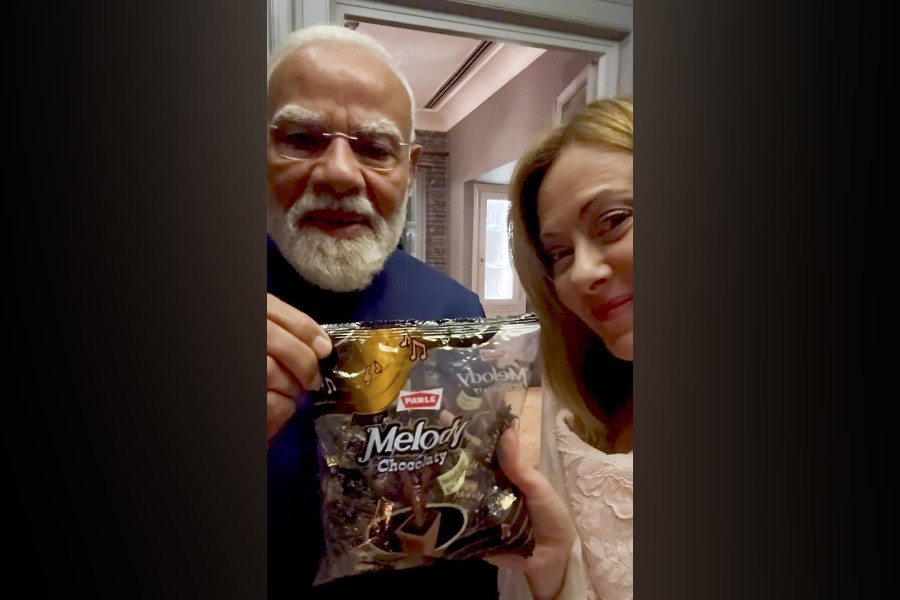 In this image screengrab from a video on May 20, 2026, Prime Minister Narendra Modi gifts a pack of toffees to his Italian counterpart Giorgia Meloni during a meeting, in Rome, Italy.