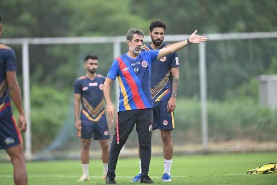 East Bengal coach Oscar Bruzon gives instructions as Miguel Figueira looks on during Wednesday's practice session at the Salt Lake Stadium Training Ground.