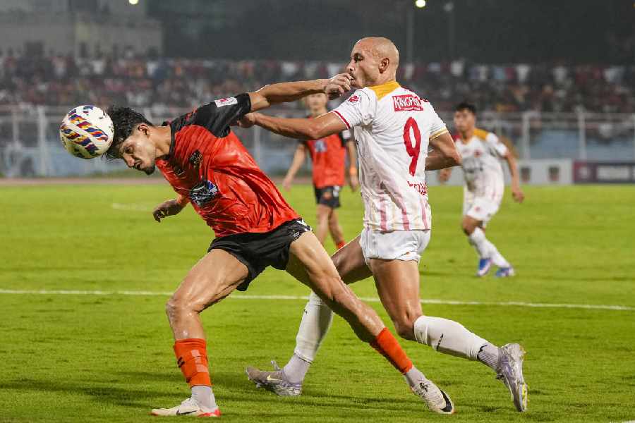 An Inter Kashi player clears the ball in front of East Bengal striker Youssef Ezzejjari (right) during Thursday's ISL-12 match at the Kishore Bharati Stadium.