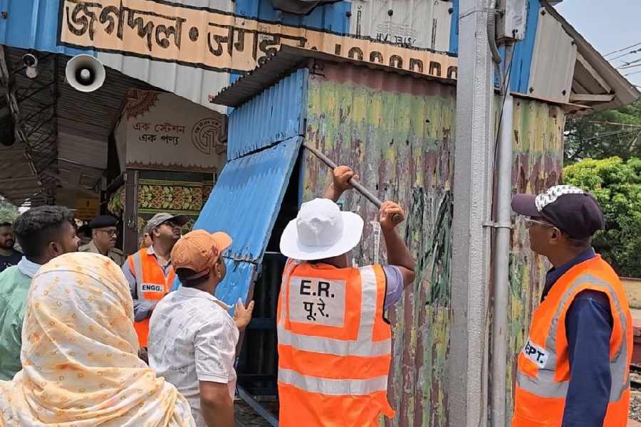 A hawker’s shanty being dismantled at Jagaddal railway station on Monday