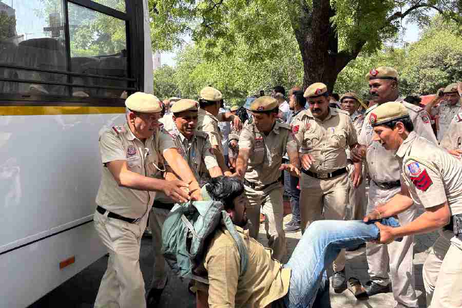 A CPI(M) party worker being dragged by the police
