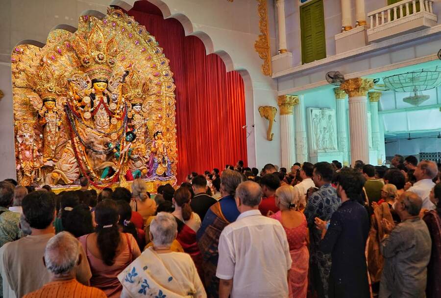 At Maddox Square in south Kolkata, crowds assembled early in the morning at the pandal to chant prayers in unison as priests distributed fresh flowers for the morning offering. 