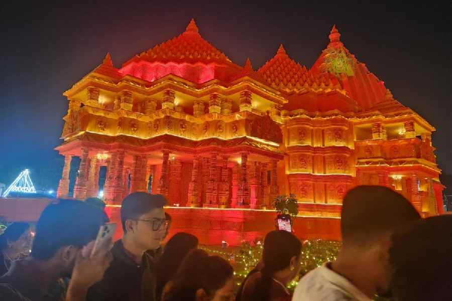 Visitors walk by the BJ Block pandal, modelled on the Somnath temple 