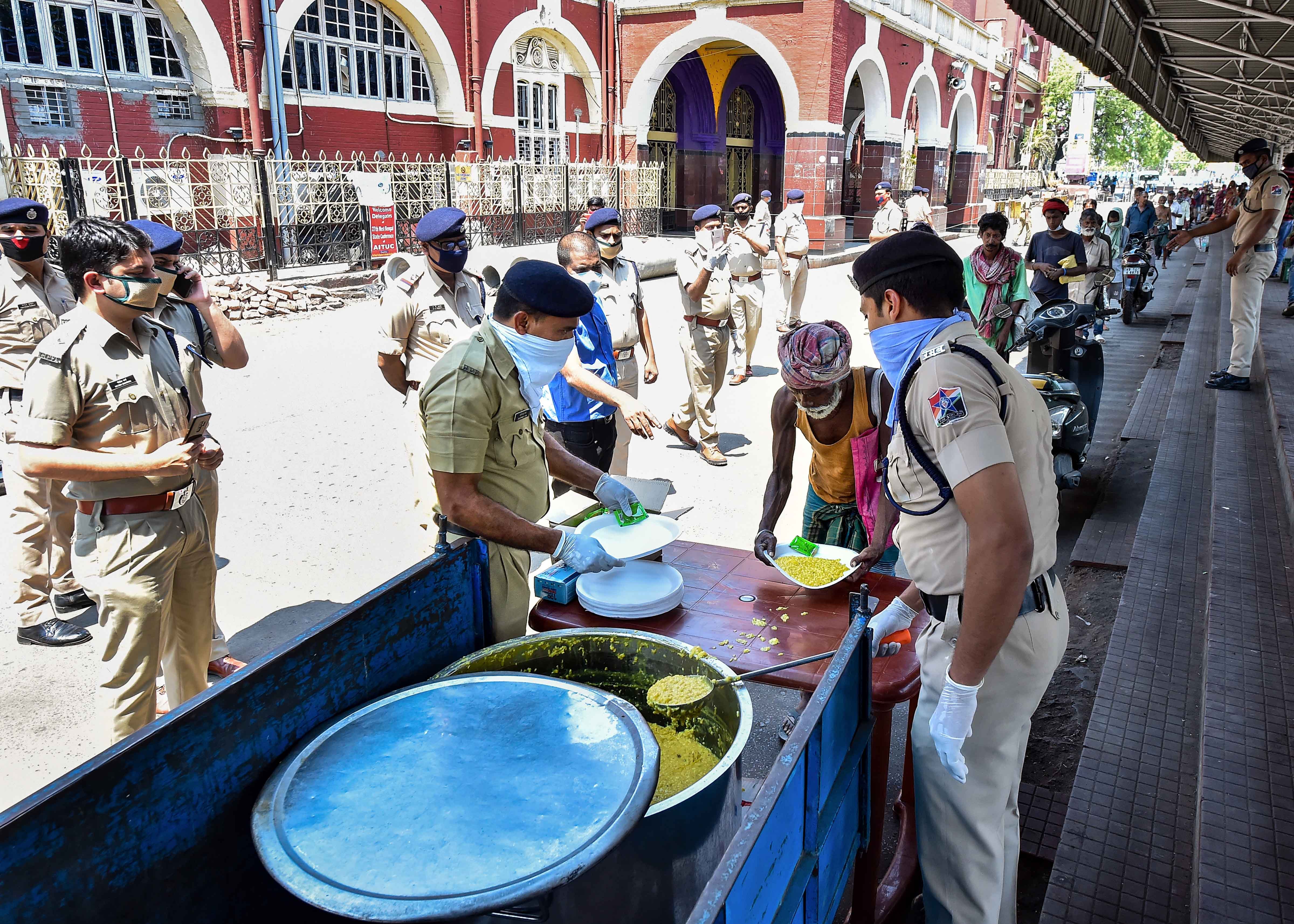 Railway Protection Force (RPF) personnel distribute food among the needy during a nationwide lockdown in the wake of coronavirus pandemic, in Calcutta, Sunday, March 29, 2020