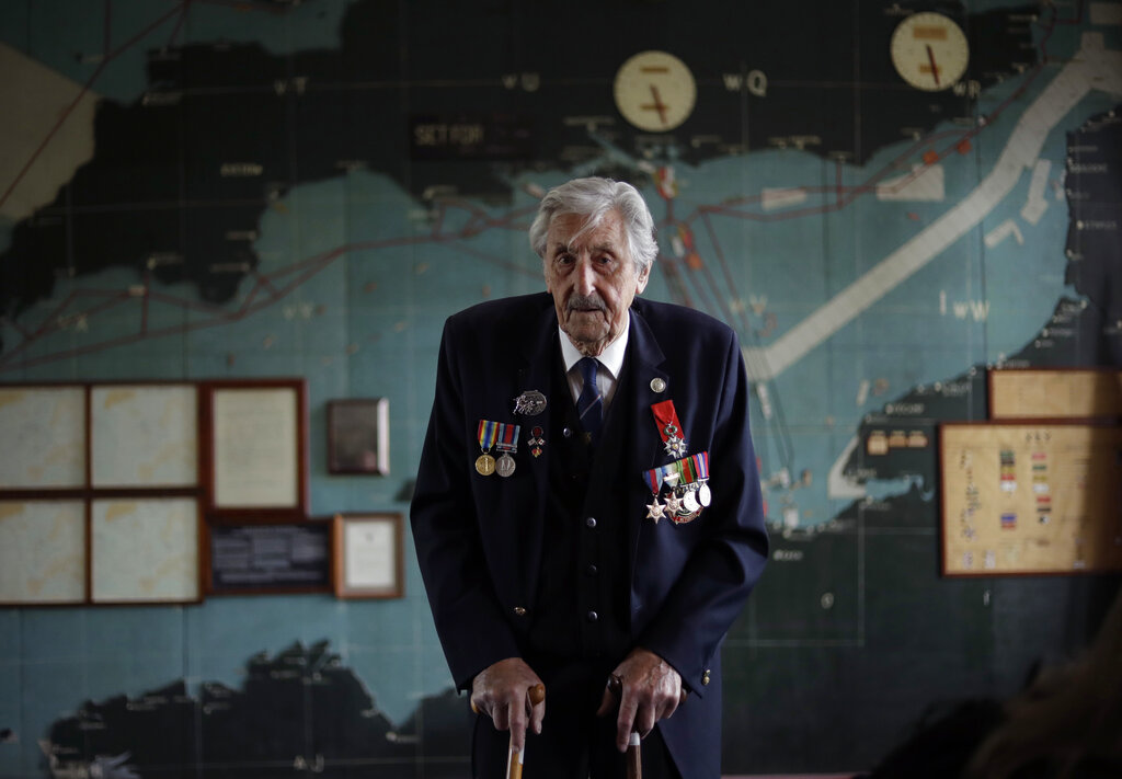 British D-Day veteran Leonard 'Ted' Emmings, who was a naval Coxswain serving on a small landing craft which landed 36 Canadians on Juno beach in France, poses for photographs backdropped by the map used to plan the Normandy D-Day landings at Southwick House near Portsmouth, England. Southwick House was the forward headquarters of the allied forces preparing for the invasion of Normandy in 1944, the nerve centre of D-Day.