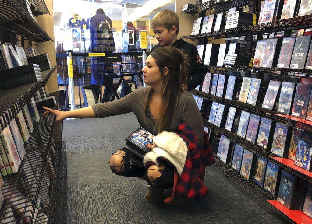 Tia Thiel and her son, Micah Knox, 7, browse at the Bend Blockbuster on Monday.