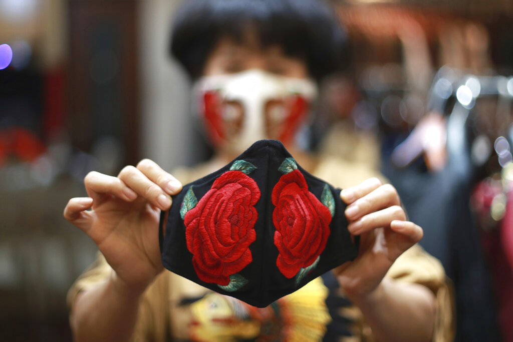 Fashion designer Do Quyen Hoa shows off an embroidery face mask at her studio in Hanoi, Vietnam. The collection of face masks adorned with Vietnamese hand embroideries was created as the world is fighting against the spread of the new coronavirus.