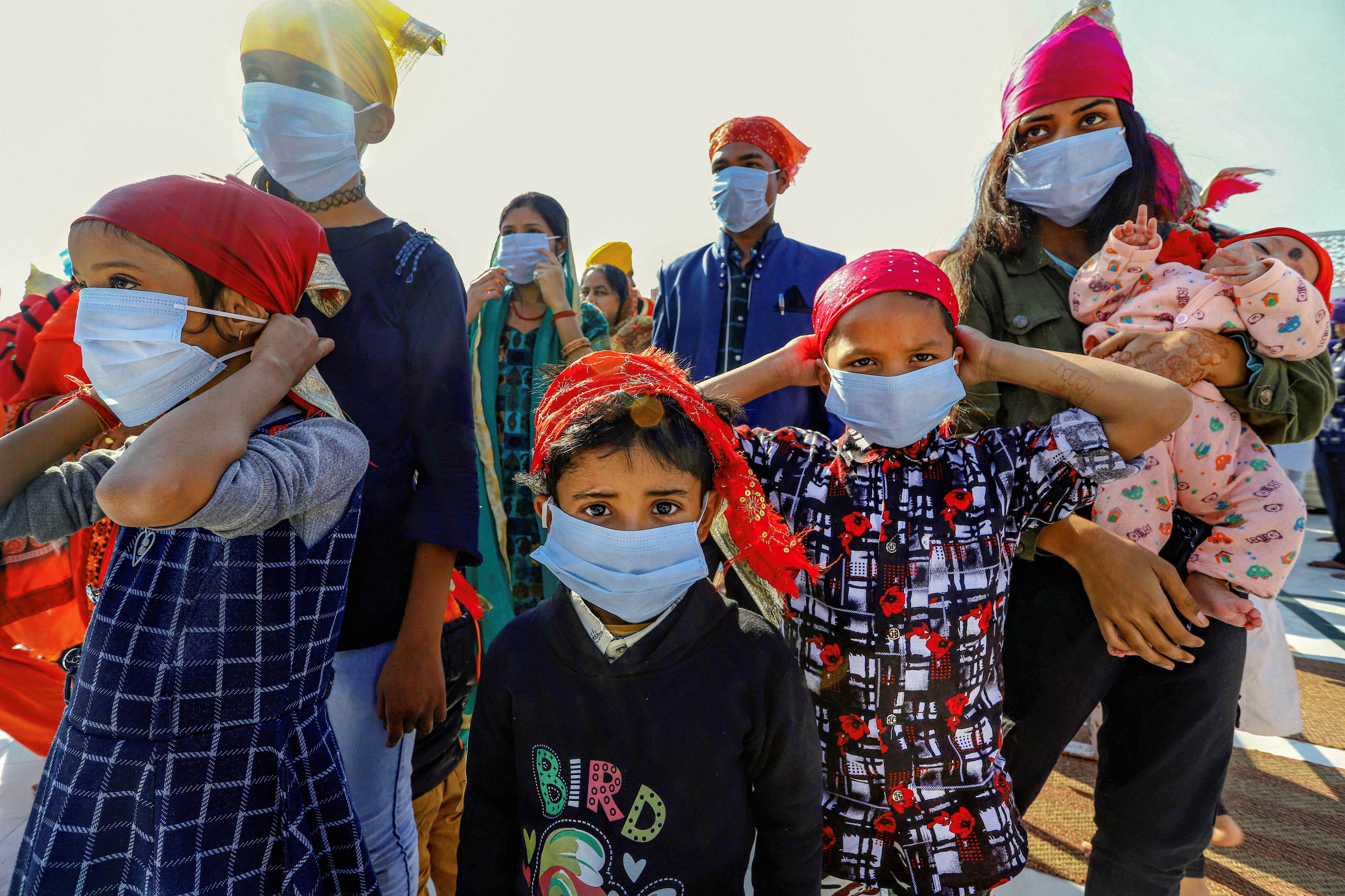 People wear protective masks during a campaign by Delhi Sikh Gurudwara Management Committee to distribute masks in the wake of novel coronavirus scare in New Delhi, Sunday, March 8, 2020