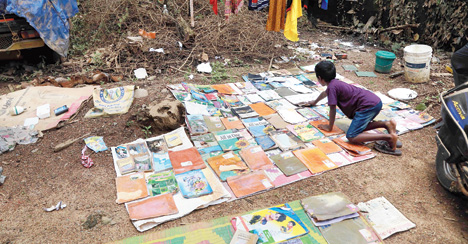 Dhanosh in Kochi, Kerala, dries out his schoolbooks