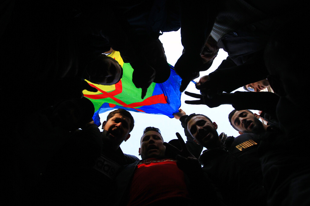 Algerian protesters flash the V sign during an anti-government demonstration in Algiers on January 3