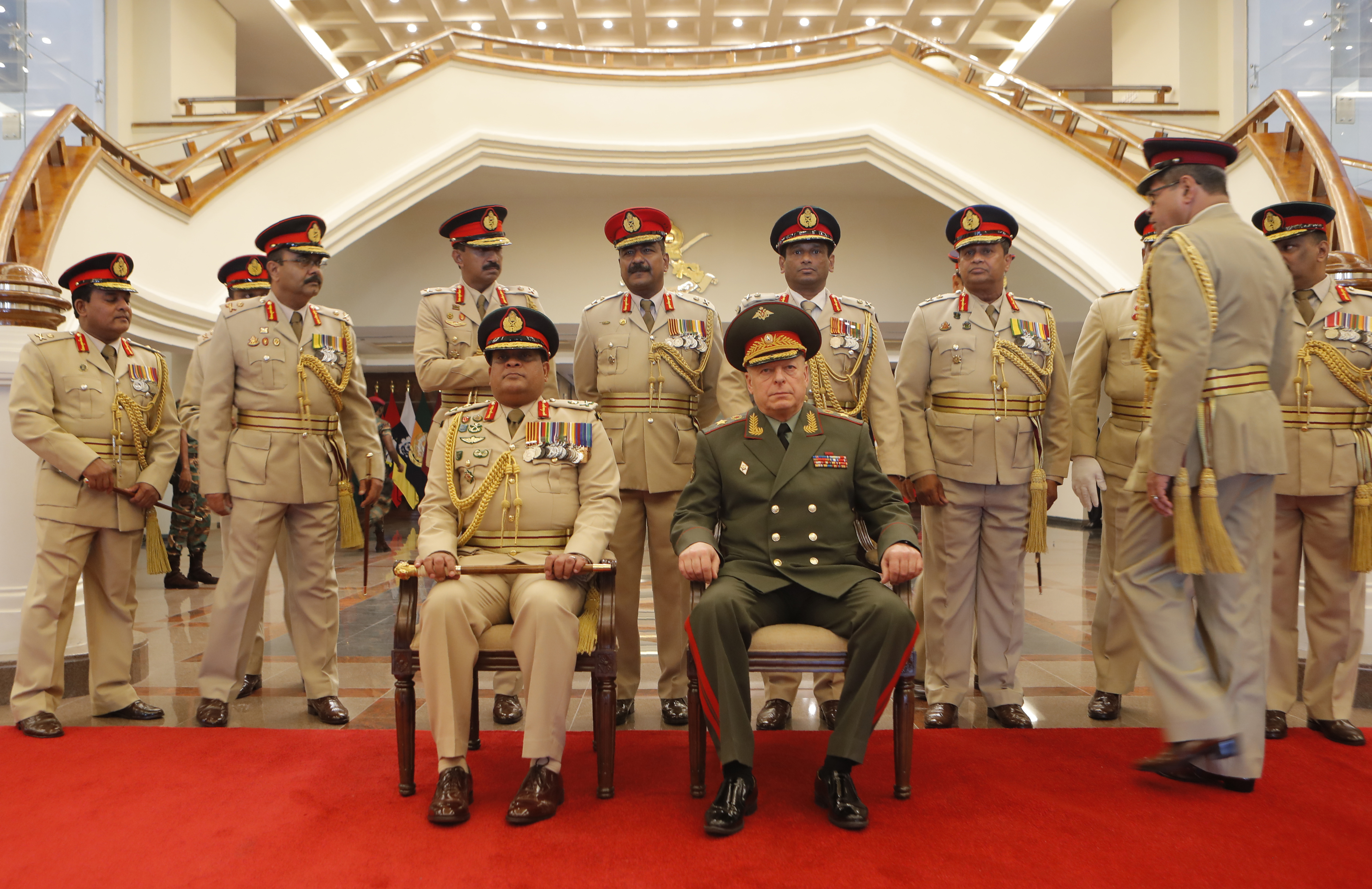 Sri Lankan army commander Lt. Gen. Shavendra Silva, seated left, along with his top command officers prepare to pose for a photograph with Russian Commander-in-Chief of the Ground Forces Colonel-General Oleg Salyukov at the military head quarters in Colombo, Sri Lanka on Monday