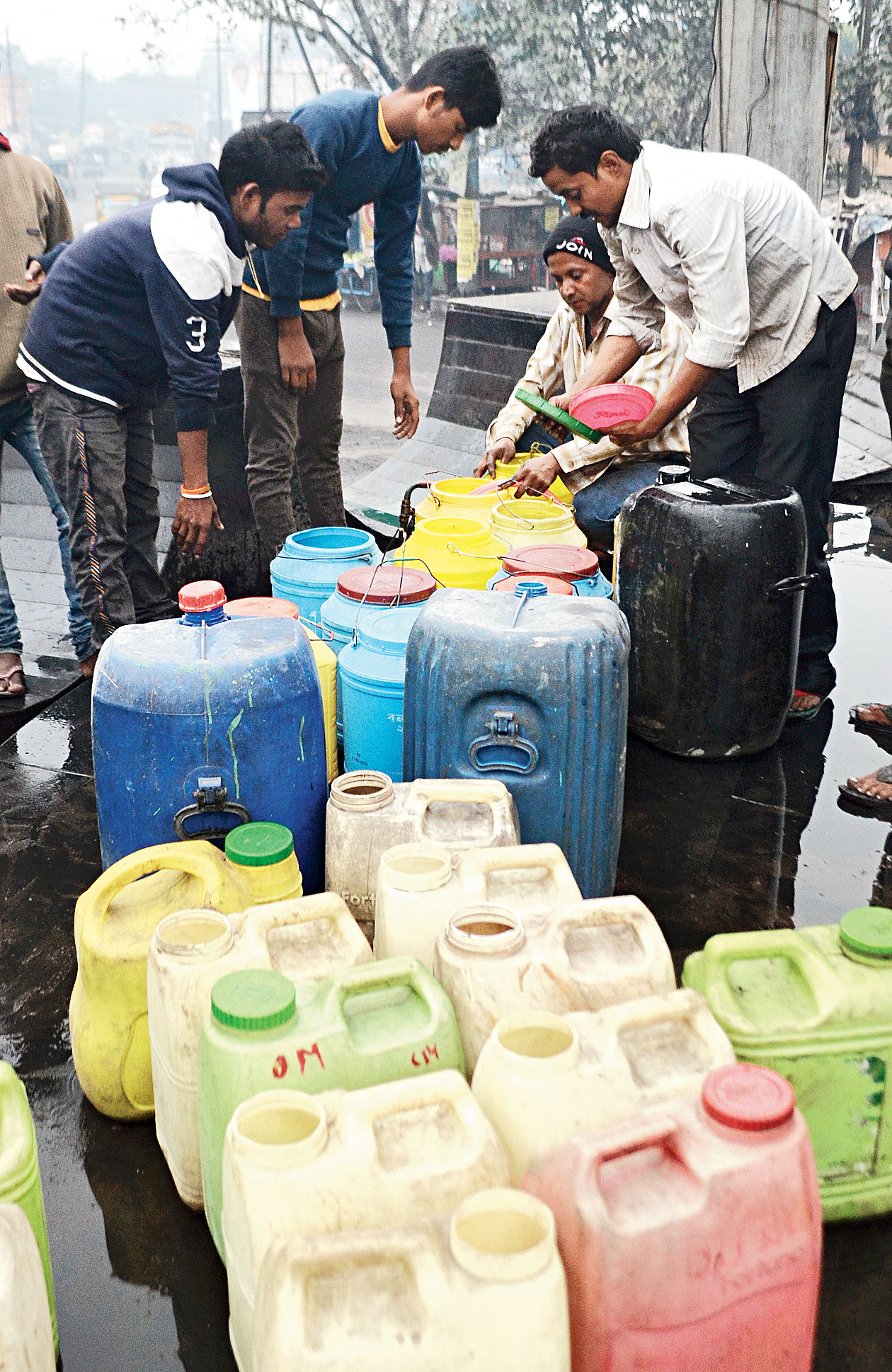Residents collect water from a water stand post at Katras Mor in Jharia, Dhanbad, on Thursday. 