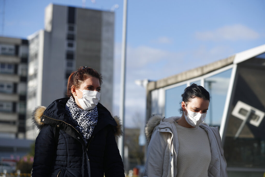 Women arrive at a Coronavirus checking center in a Mulhouse hospital, eastern France, Monday March 9, 2020.