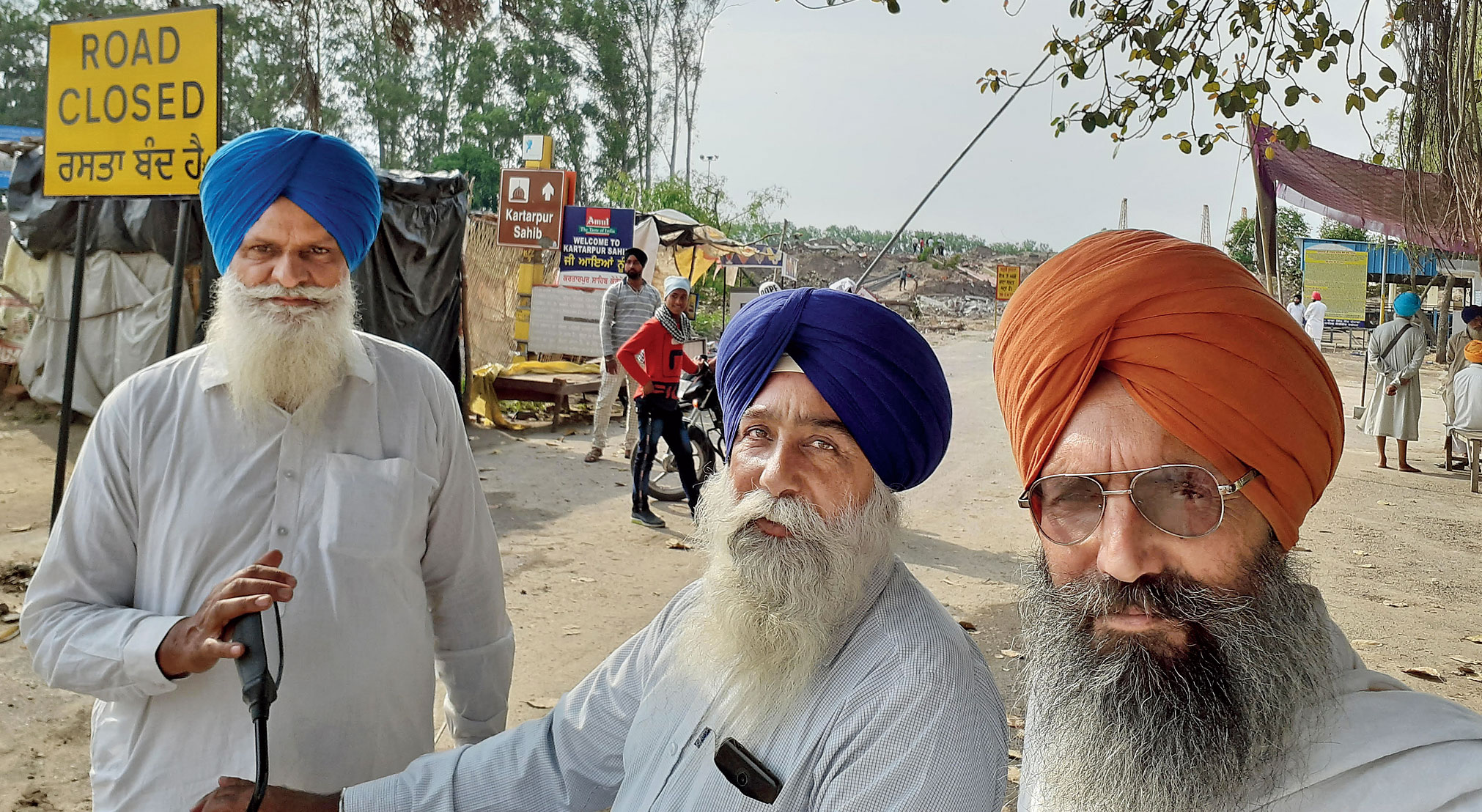 (From left) Farmers Satnam Singh, Gurmeet Singh, and Jaspal Singh near the Kartarpur corridor. 