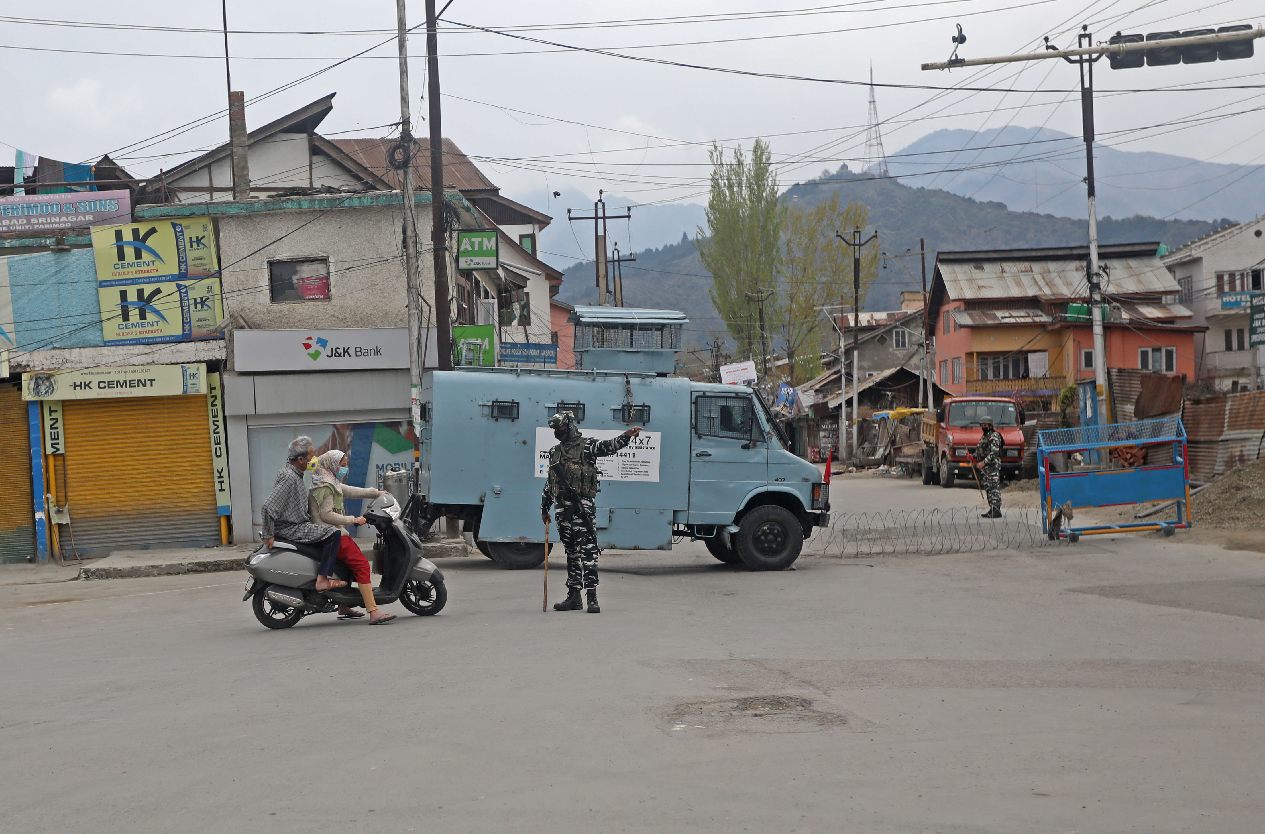 GO BACK: A CRPF man turns away a woman and her companion on a scooty at Nowpora Khayam, Srinagar.