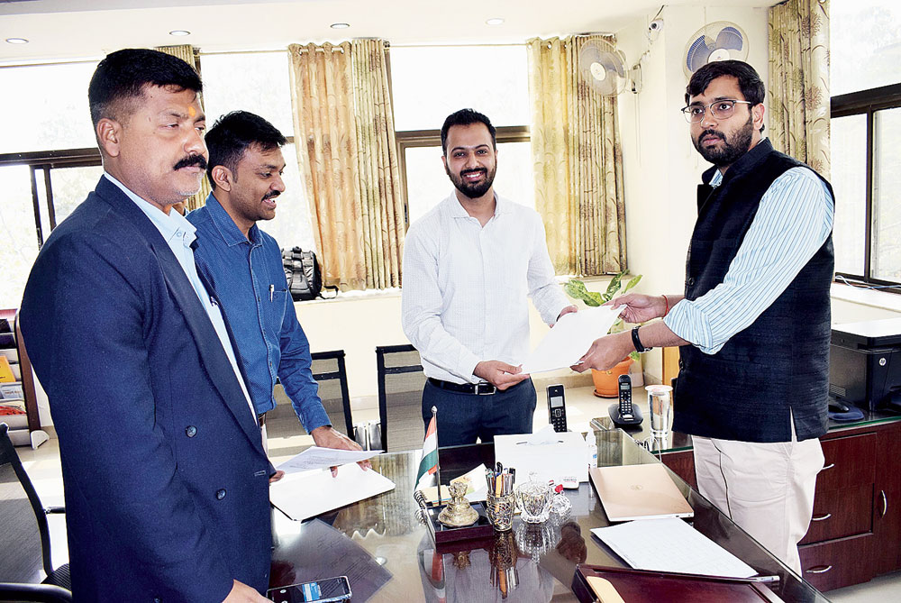 Ranchi DC Rai Mahimapat Ray (right) and UNDP project officer Manish Mohandas exchange files after signing the MoU in Ranchi on Tuesday. 