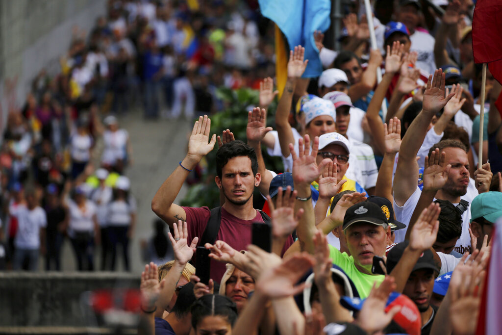 Anti-government protesters during the symbolic swearing-in of Juan Guaido at a rally demanding President Nicolas Maduro's resignation in Caracas, Venezuela, on Wednesday.