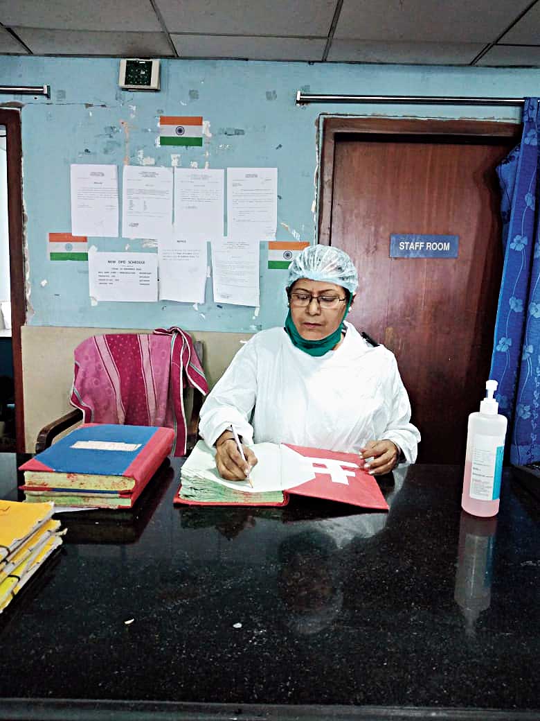 Manika Chaudhury, who has been sister-in-charge of the quarantine ward at ESI hospital, completing paperwork