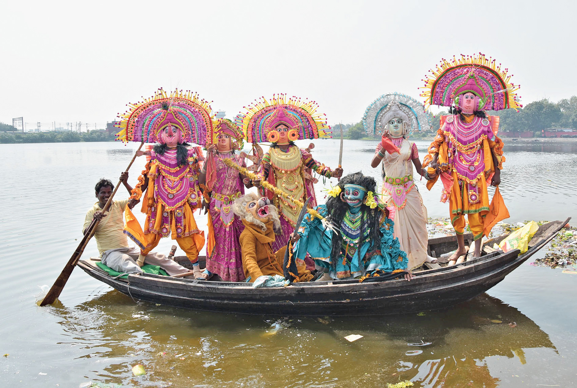 Chhau artistes perform Mahishasurmardini on a boat in Loco Tank at Hirapur, Dhanbad, to mark the victory over evil.