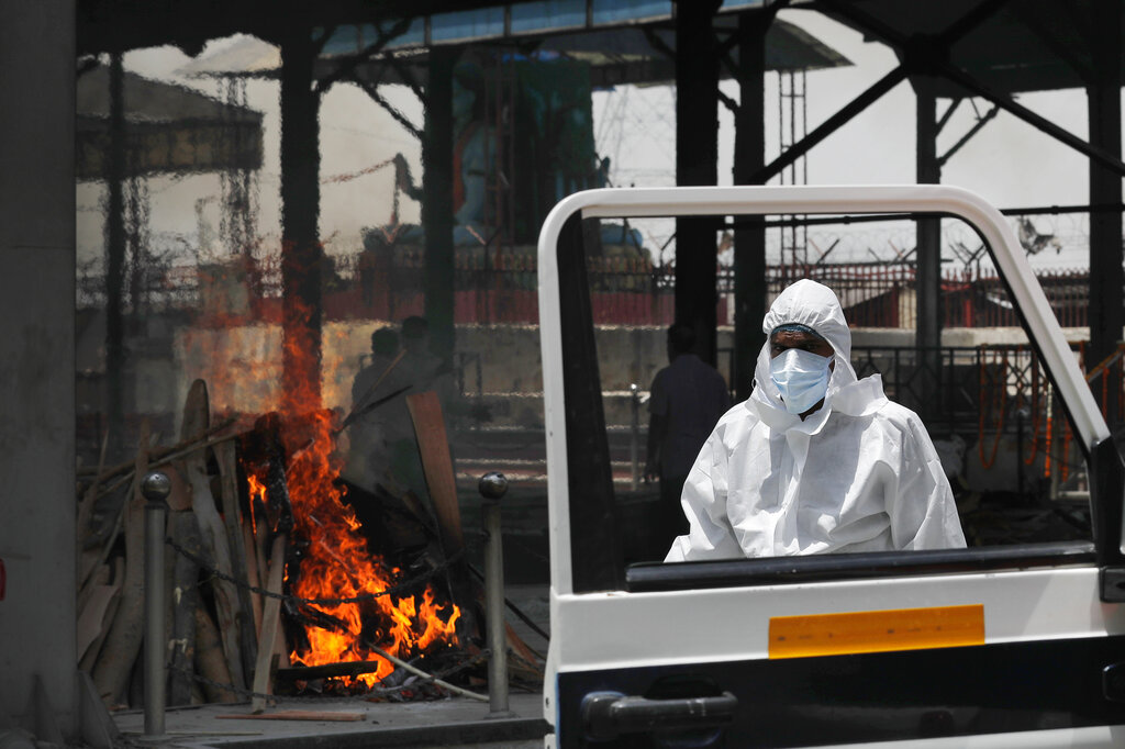 The driver of an ambulance returns after helping cremate the body of a woman who died of Covid 19 on a handcart for cremation in New Delhi, on Thursday, May 28, 2020.