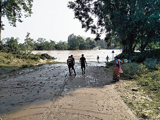 Local residents near the washed away Malkangiri-Kalimela road.