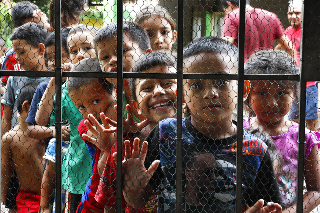 Migrant children line up for a meal at the door of a shelter at Tapachula in the Chiapas state of Mexico on May 30.