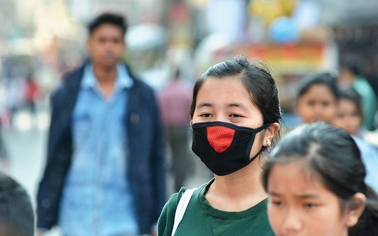 A girl dons a mask as a preventive measure against coronavirus in Guwahati
