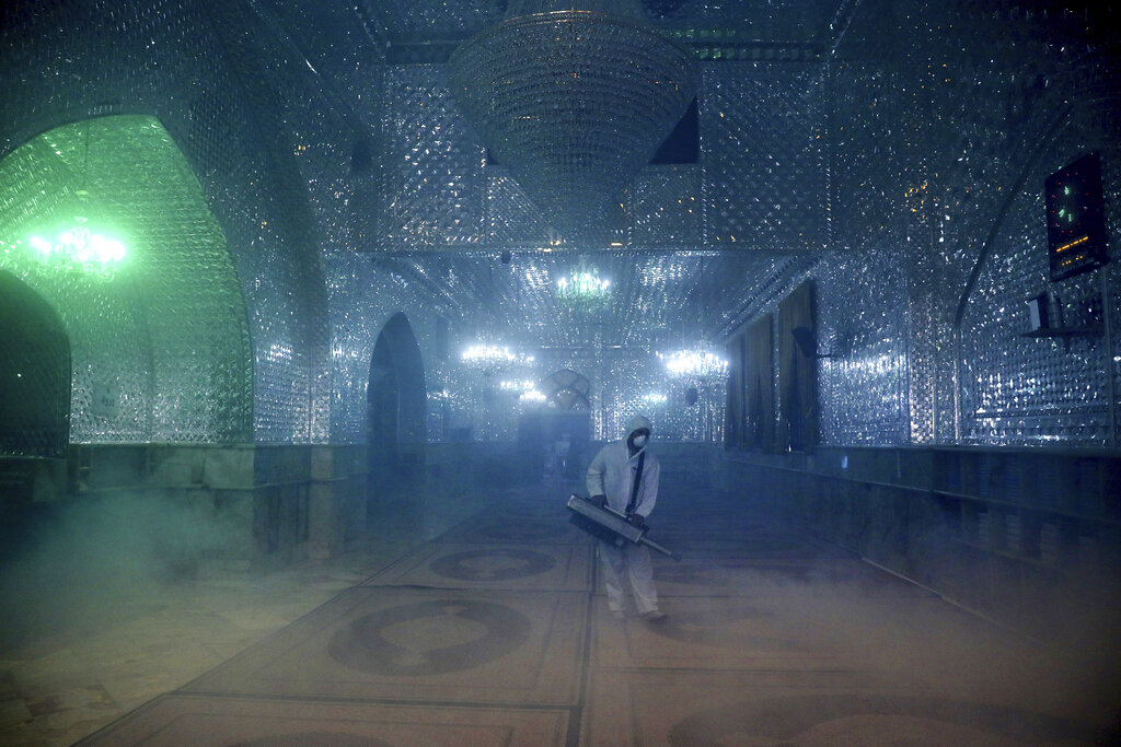 A firefighter disinfects the shrine of Saint Saleh to help prevent the spread of coronavirus in Tehran.