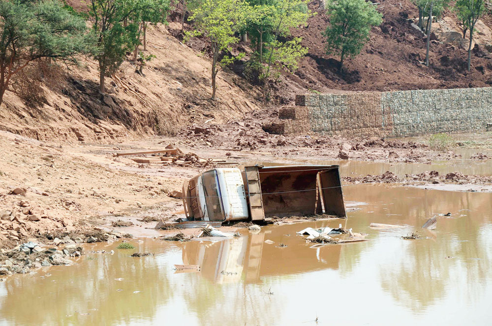 One of many trucks and earthmovers that had keeled over after a pond of industrial waste collapsed, spilling red mud (bauxite residue) over 35 acres and onto nearby railway tracks at Muri on Wednesday. 