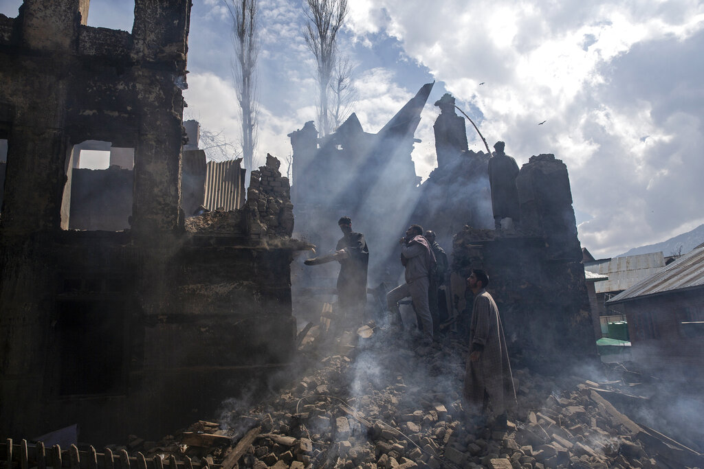Kashmiri men dismantle a portion of a house destroyed in a gunbattle in Tral village, south of Srinagar, March 4, 2019. The image is part of the photo series that won the 2020 Pulitzer Prize for Feature Photography.