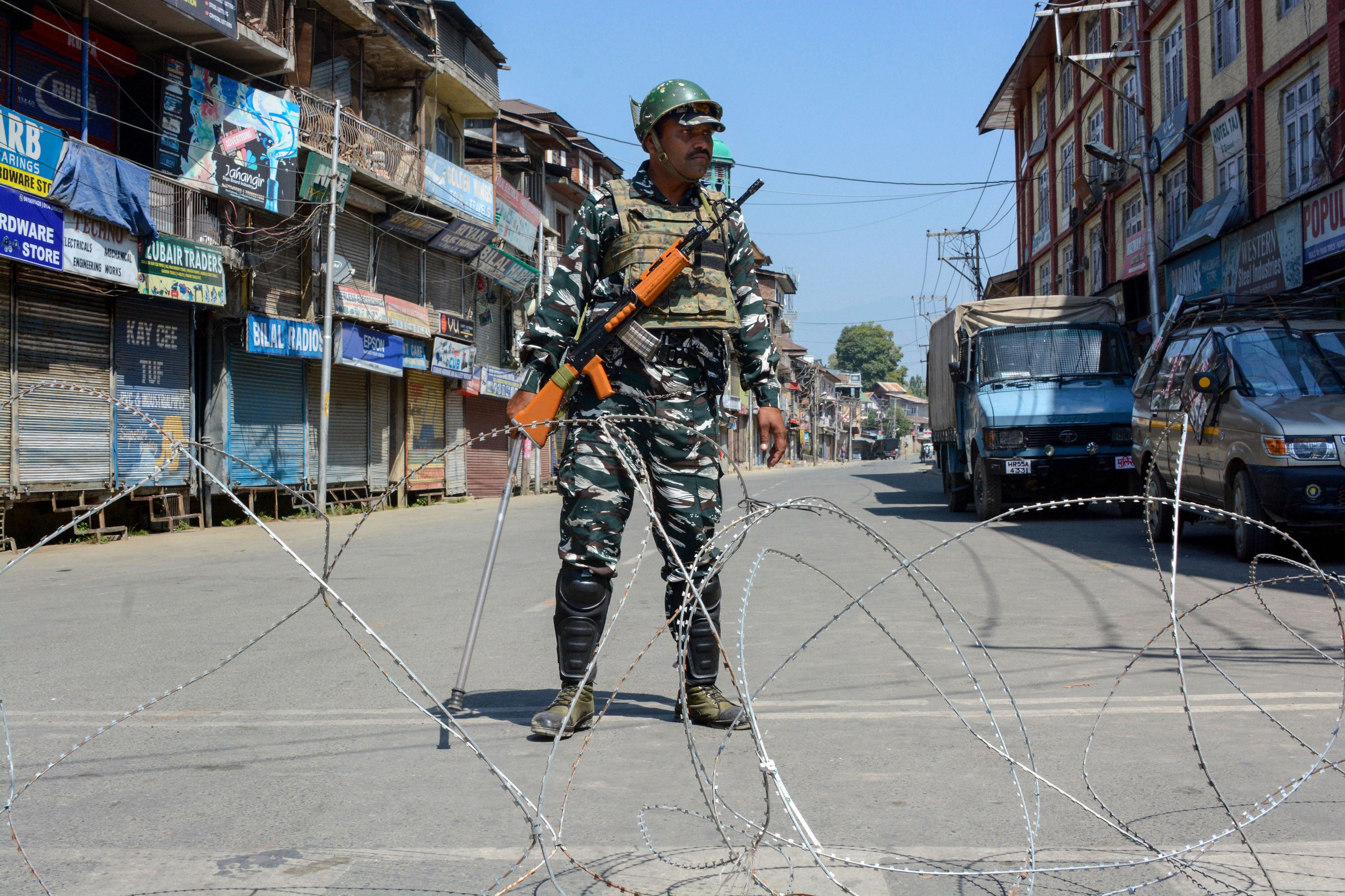 A security personnel stands guard at a blocked road during restrictions were reimposed in Srinagar, Monday, September 9, 2019.