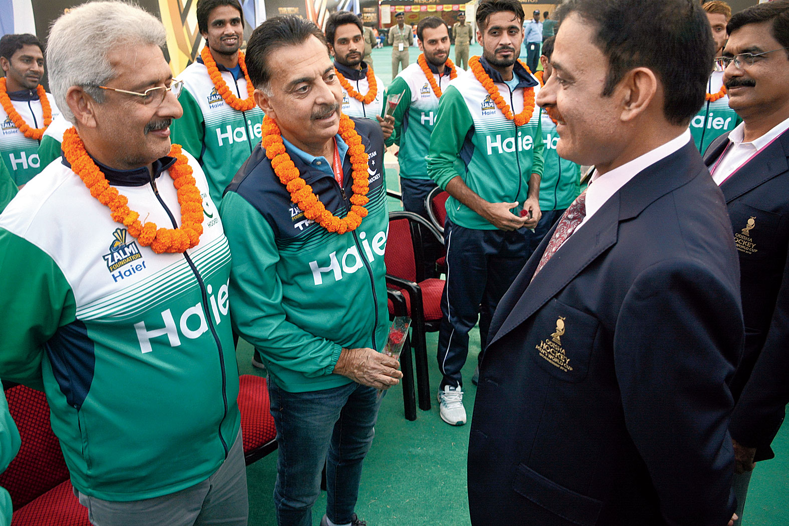 Pakistani hockey team officials exchange pleasantries with a police officer at the police kiosk at the Fan Village in Bhubaneswar on Monday. 