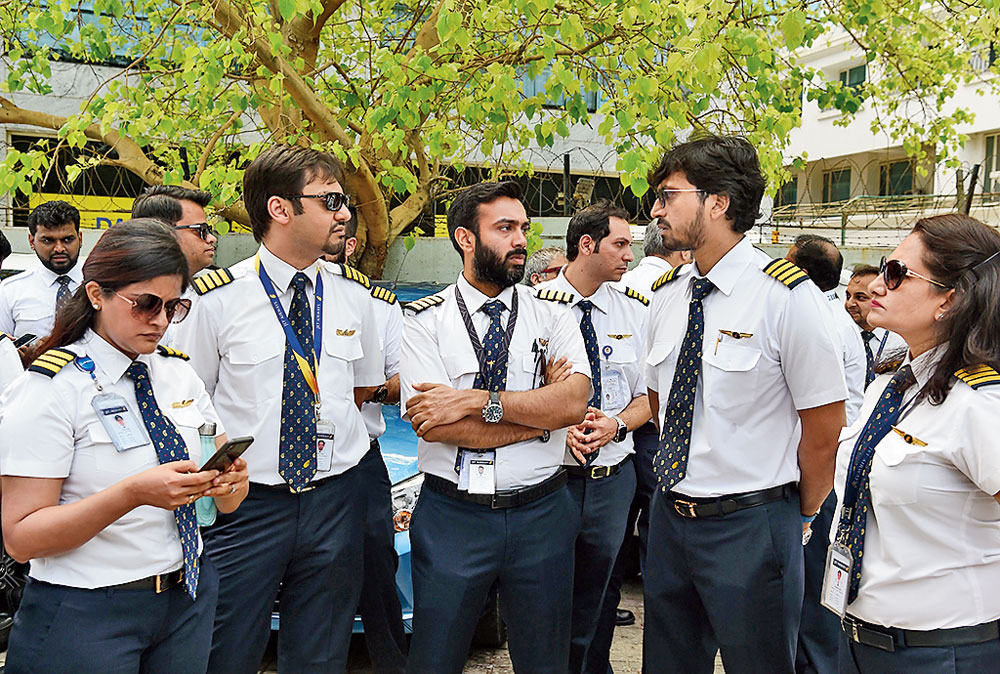 Jet Airways pilots and engineers assemble outside the Jet headquarters in Mumbai on Monday. 