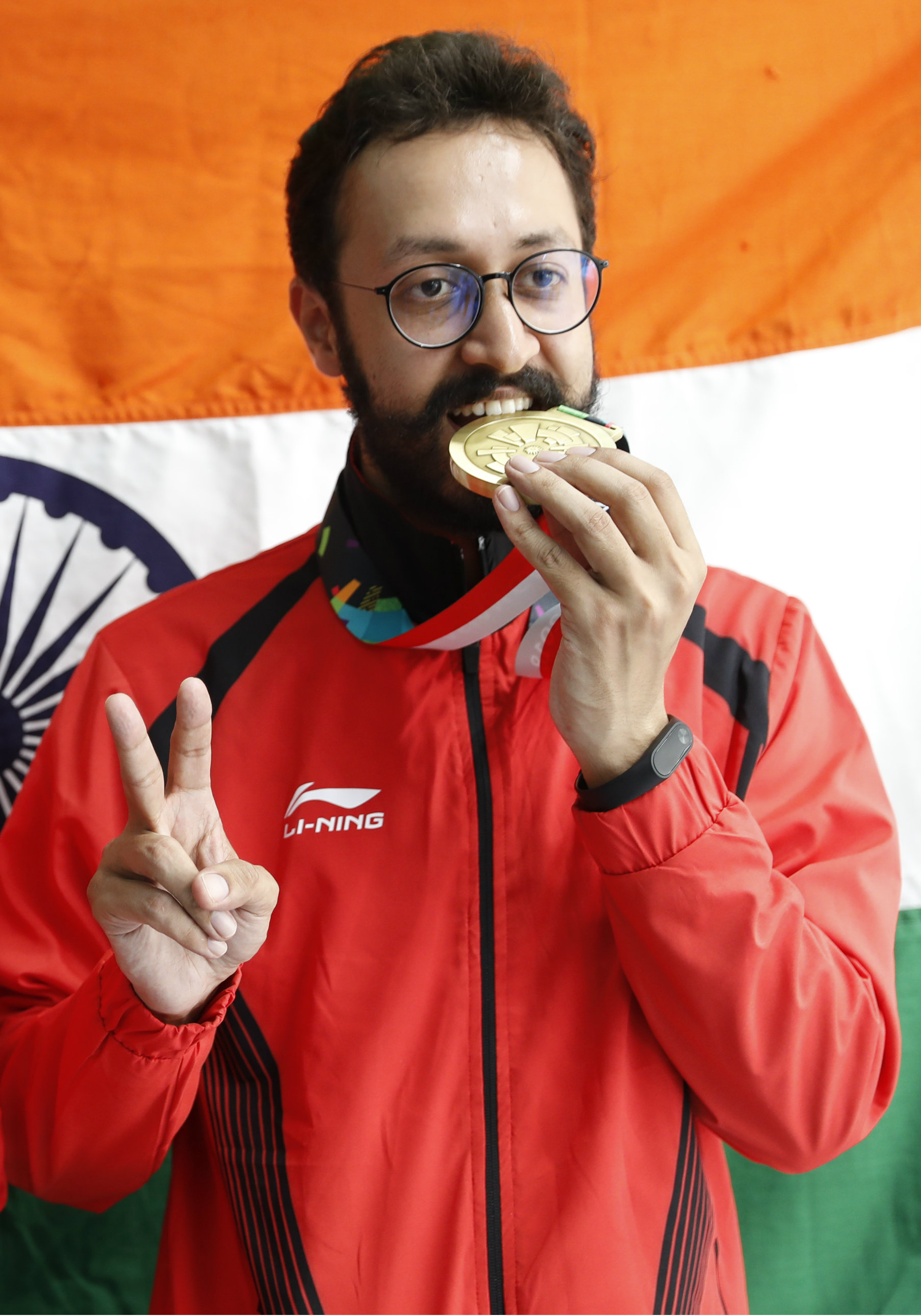 Abhishek Verma gets a taste of his bronze medal.