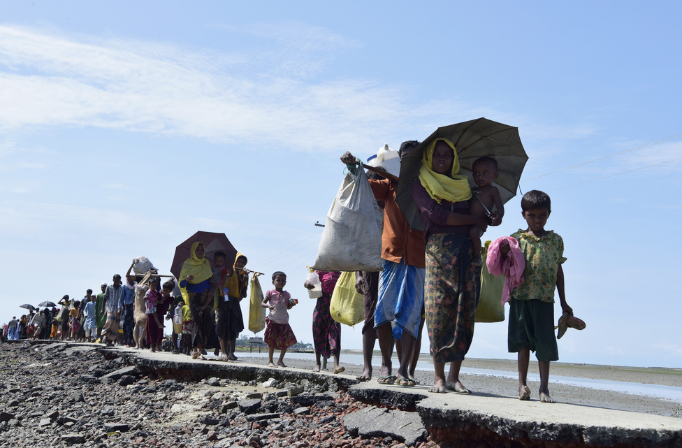 Members of Myanmar's Rohingya minority walk on a broken road in Cox's Bazar, Bangladesh (file photo, September 11, 2017).