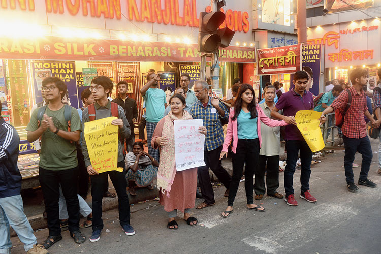 Scottish Church College students and others hold up posters in support of Jamia Millia Islamia and Aligarh Muslim University students