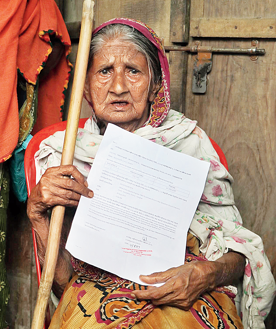 Talu Necha, a 106-year-old woman, shows her NRC documents on Monday.