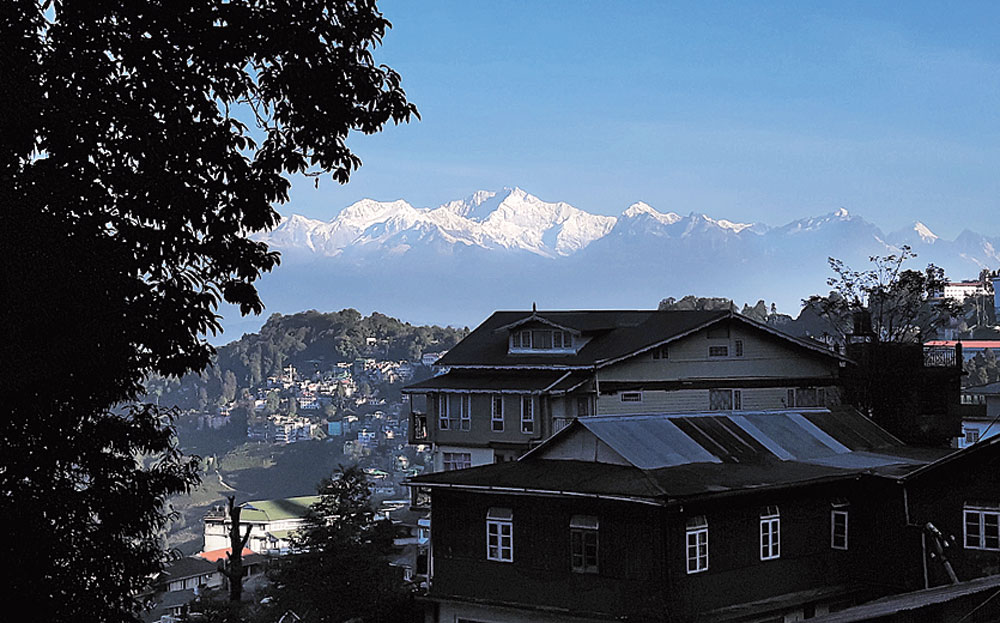 A settlement in Darjeeling with the Himalayas in the background.
