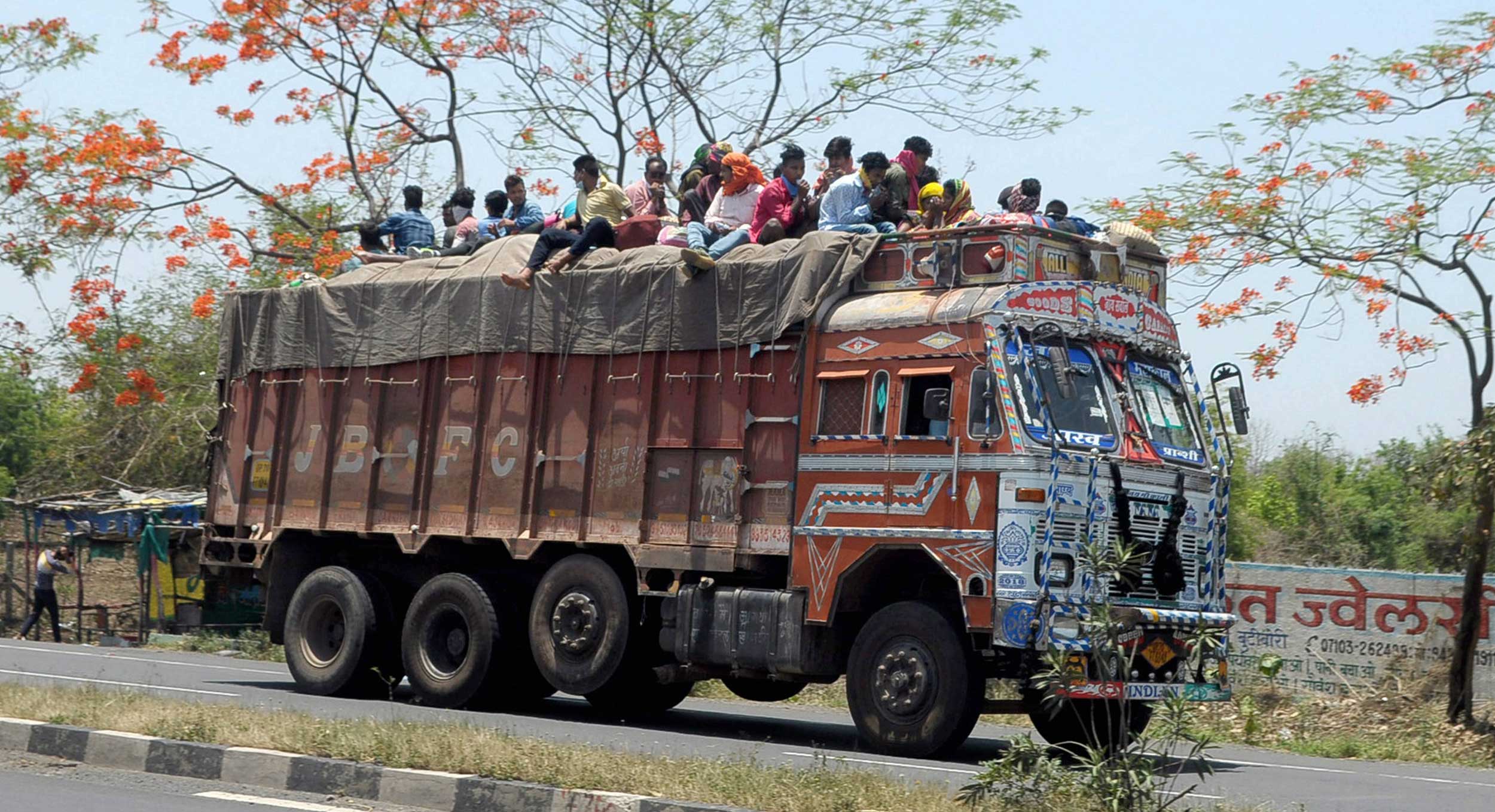 Migrant workers travel atop a loaded truck to their native places in Nagpur on Wednesday. The trucks, registered in Haryana, have been seized and the migrants were sent back to their accommodation on Friday.
