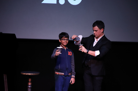 Magu with the author's son conducting a trick where he asks the boy to upturn a glass full of water on his head