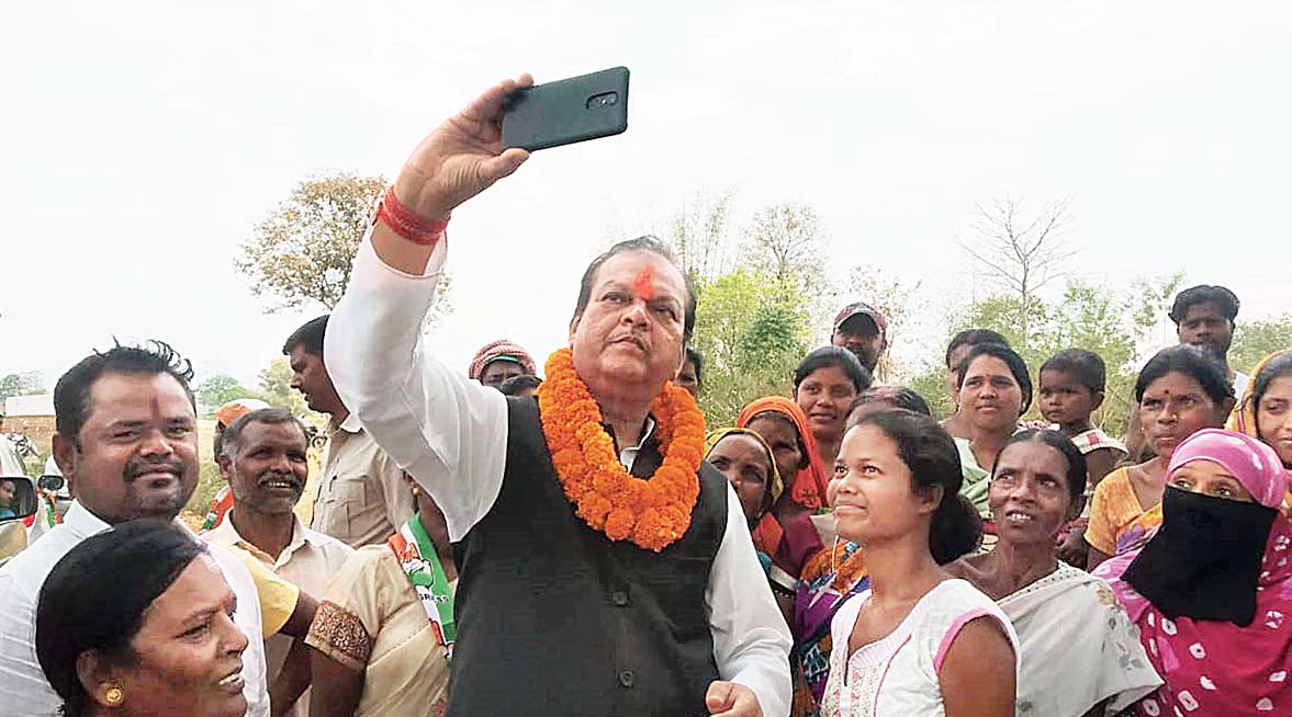 Subodh Kant Sahay clicks a selfie with villagers in Ranchi on Saturday.