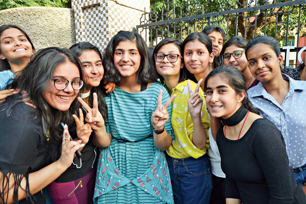 We did it! Nandani Choudhary with other students flash the victory sign at Loreto Convent in Ranchi after Class X results were declared on Tuesday. 