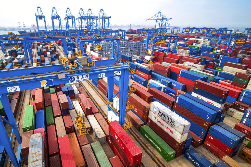 In this May 14, 2019, file photo, containers are piled up at a port in Qingdao in east China's Shandong province. China’s economic growth slowed to a 26-year low in the latest quarter as a tariff war with Washington weighed on exports and auto sales and other domestic activity weakened. 