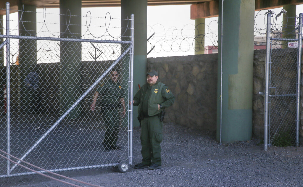 Border Patrol agents guard a gate at the entrance to what was a temporary holding facility under the Paso del Norte Port of Entry bridge in El Paso, Texas, on Sunday.