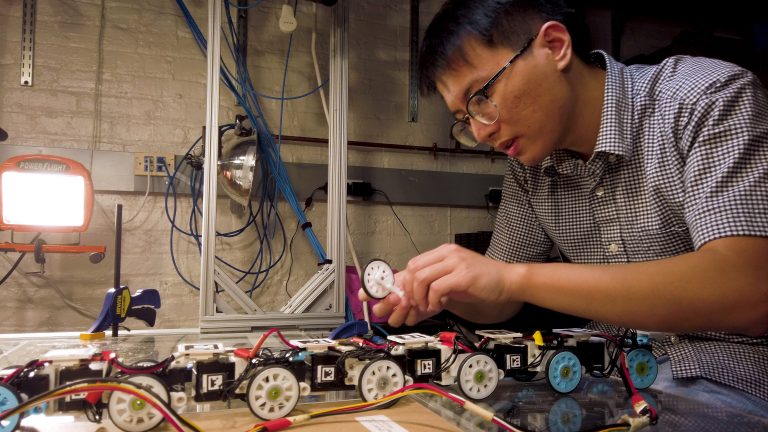 Qiyuan Fu, a graduate student at The Johns Hopkins University, works on the snake robot he built in Hopkins’ Terradynamics Lab