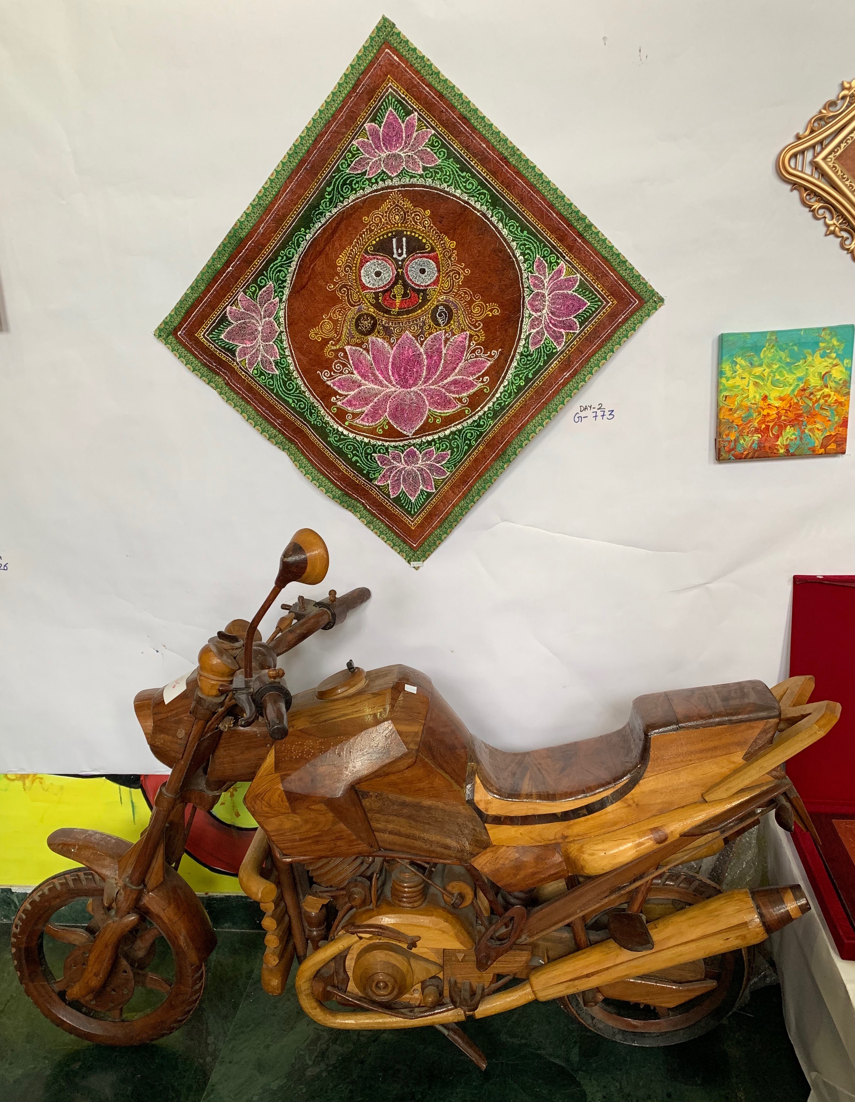 A wall hanging and a wooden bike up for auction