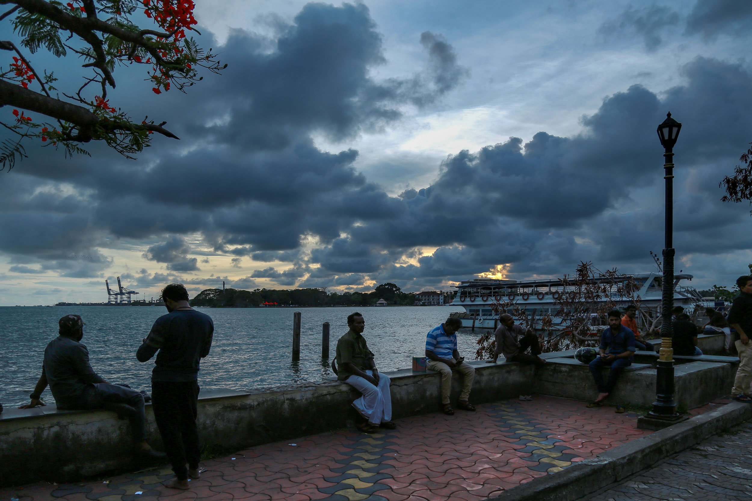 People sit near the coastline in Kochi on June 7, 2019. The IMD’s Saturday weather inference predicted that the cyclonic circulation is likely to move north-northwestward and intensify gradually.


