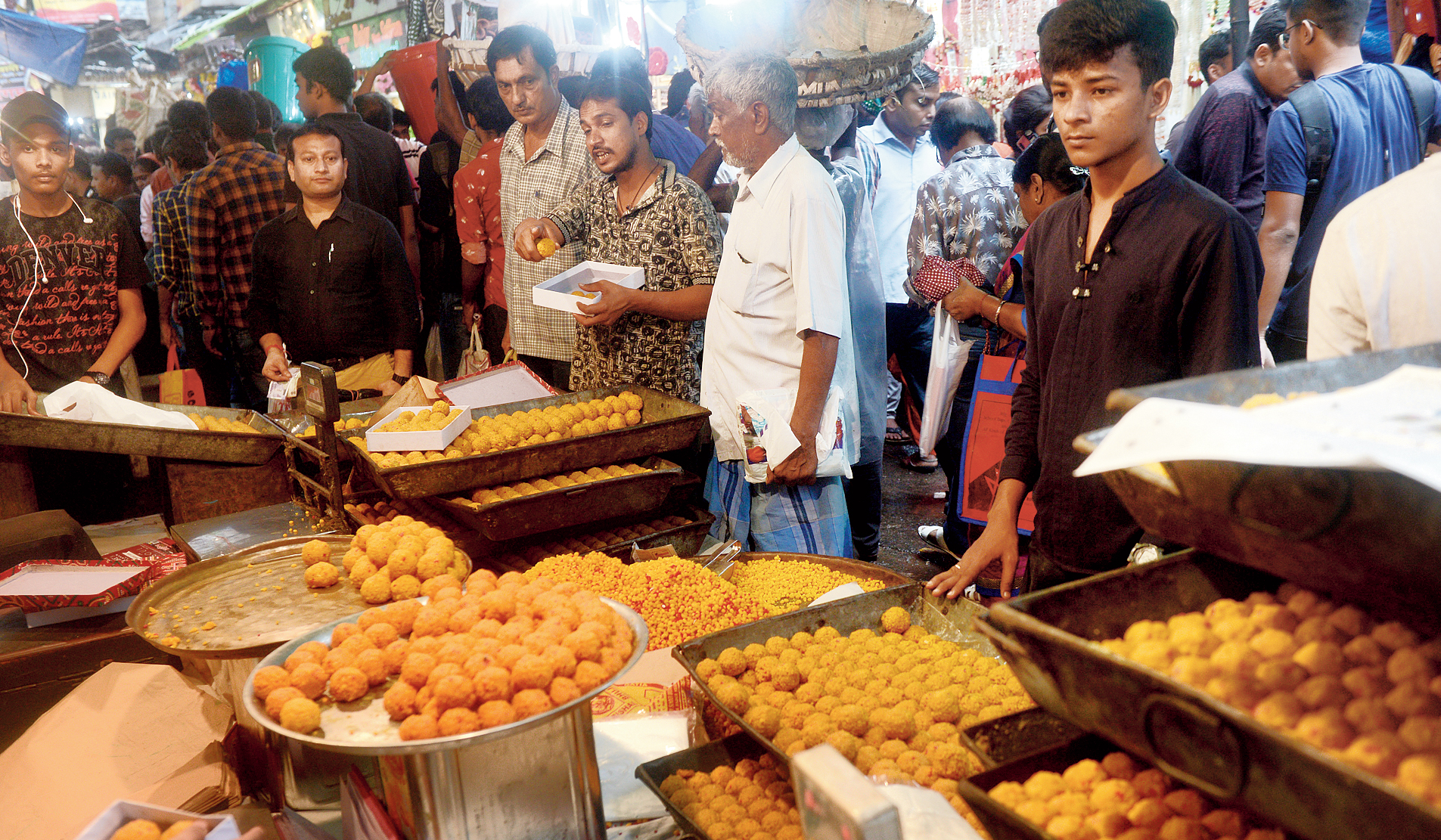 Buyers crowd a sweet shop in Burrabazar