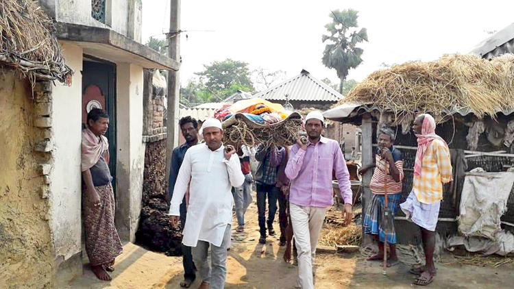 Murtoza and Mallik carry Saraswati’s body in East Burdwan’s Galsi on Wednesday. 